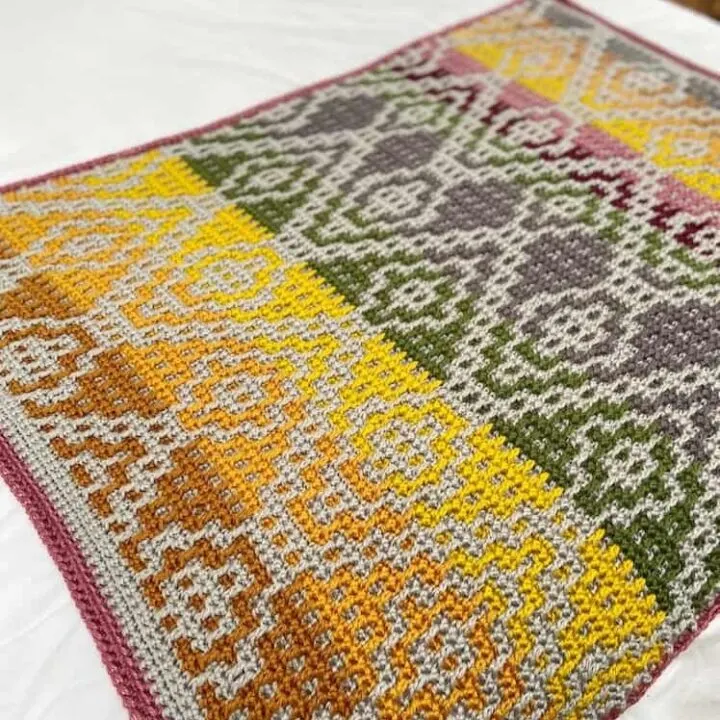 Wanderers Mosaic Crochet Blanket pattern spread out on bed