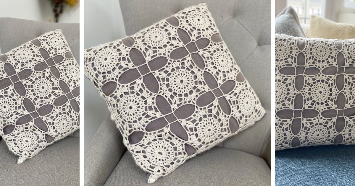 Square throw pillow on a chair, covered with gray fabric and adorned with a crochet lace square in cream, showcasing intricate floral and geometric patterns.