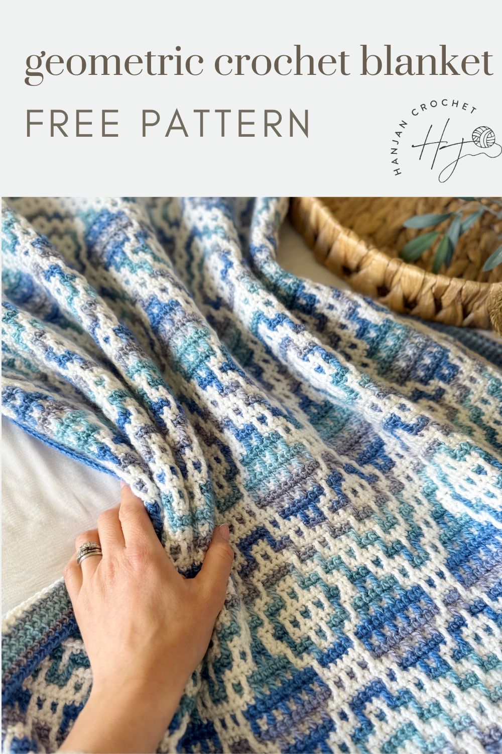 A hand touches a blue and white mosaic crochet blanket, with text above reading "geometric crochet blanket FREE PATTERN.