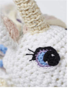 close up of amigurumi unicorn crochet eye
