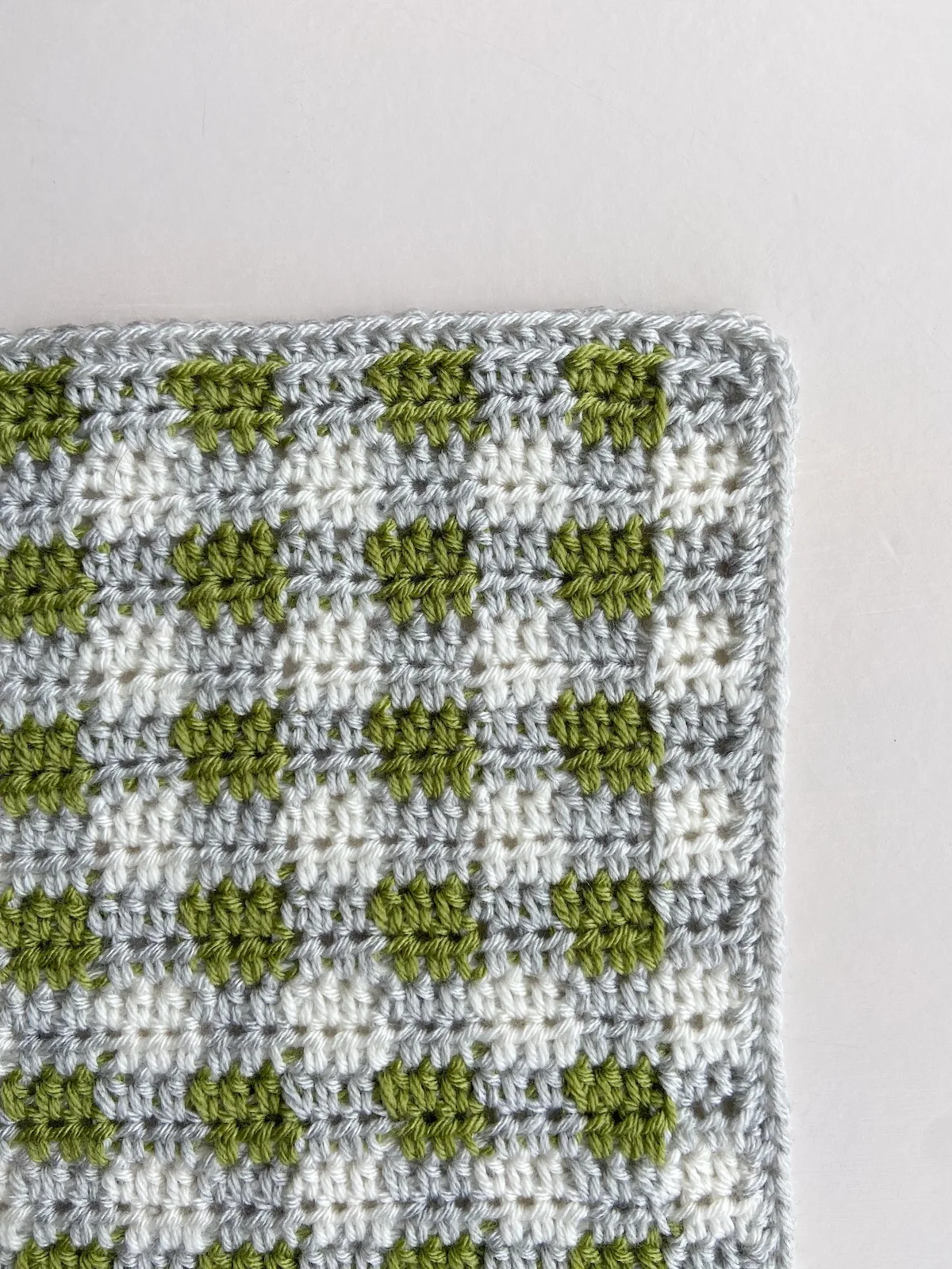 close up of crochet plaid blanket corner and border