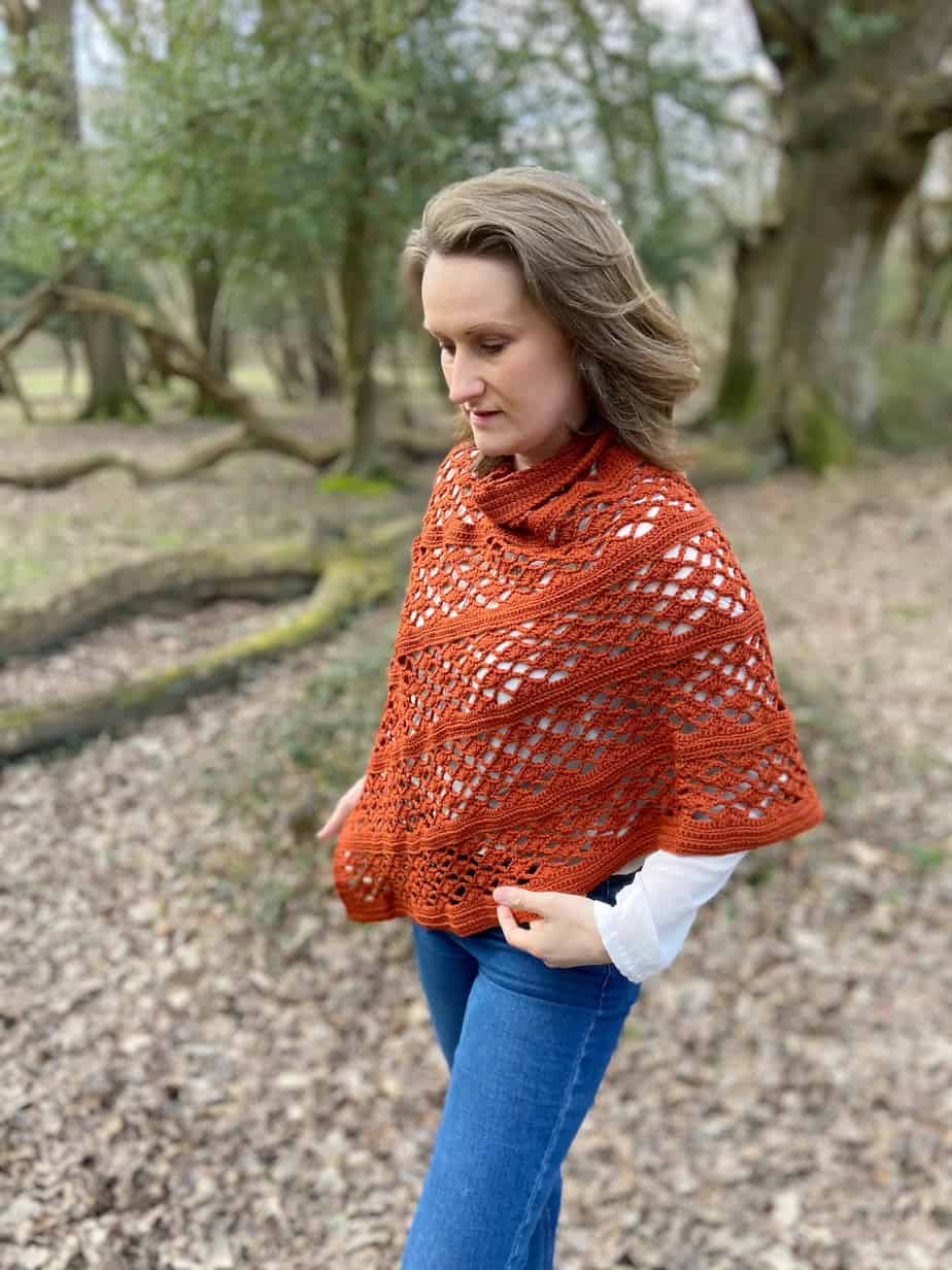 woman wearing picante crochet wrap pattern standing in woodlands
