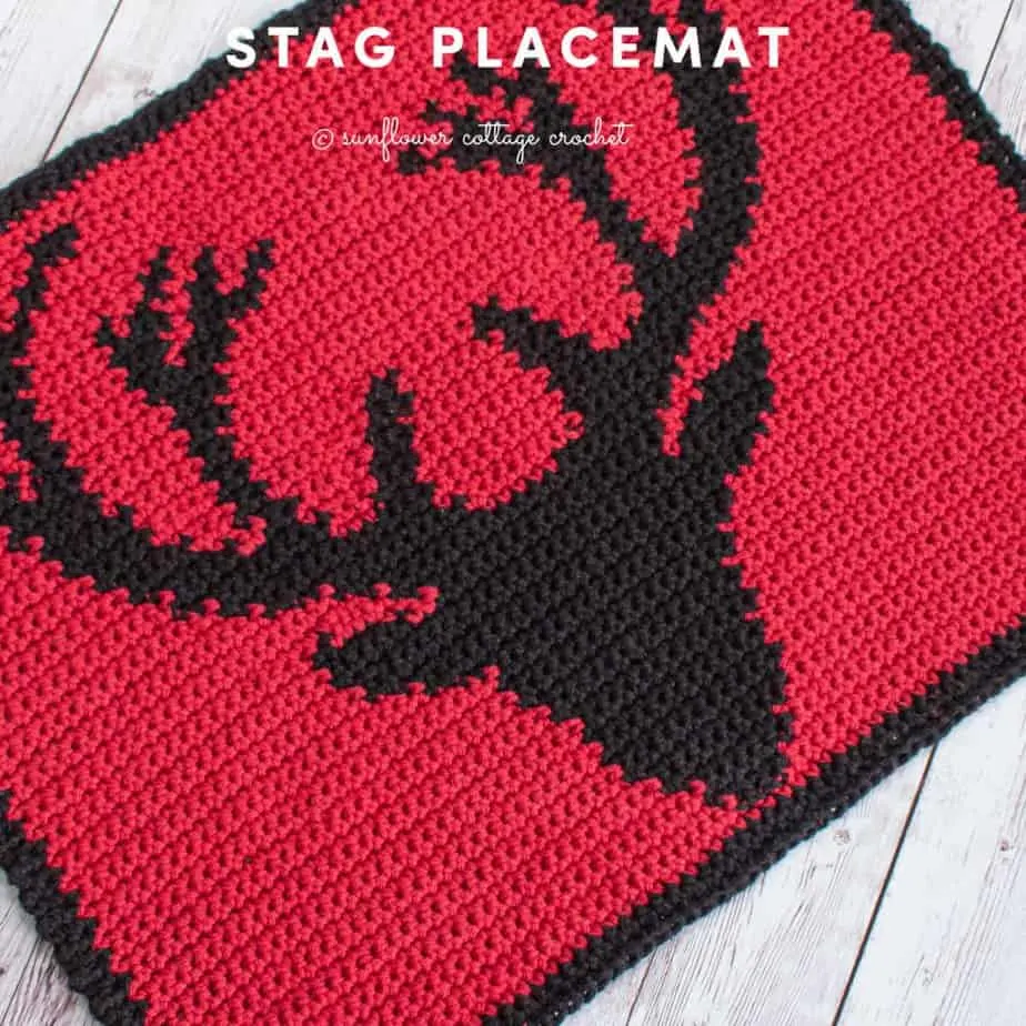 Red placemat with black stag head design.