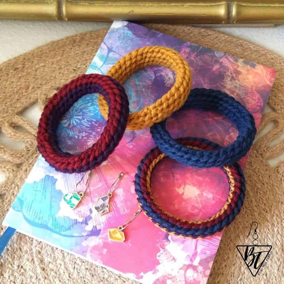 Colorful crochet bangles on a table.