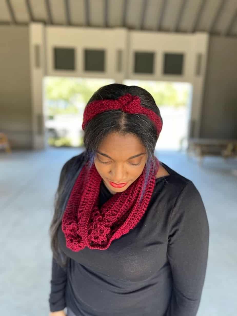 Woman wearing red headband and cowl.