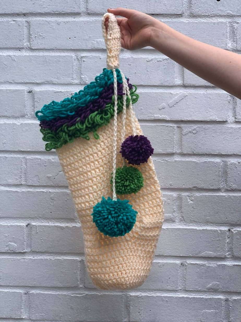 Crochet Christmas stocking with pom-poms.