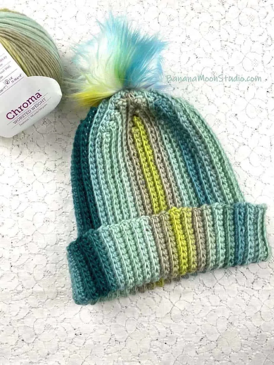 Ribbed crochet hat in shades of green.