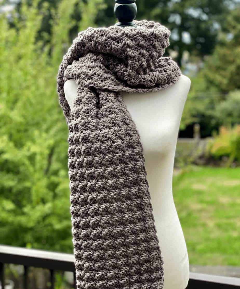Super chunky crochet scarf in grey on a mannequin. 