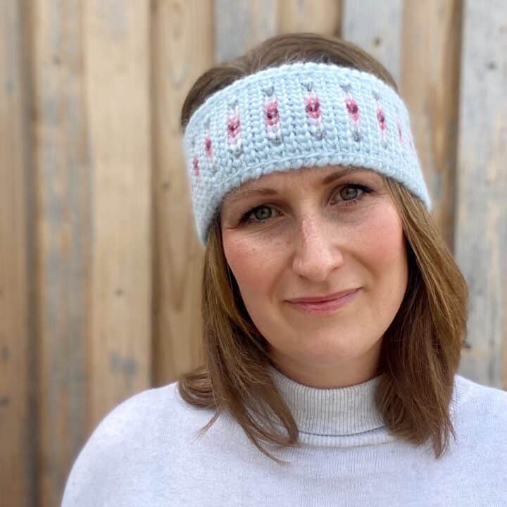 woman wearing fair isle crochet headband pattern in blue