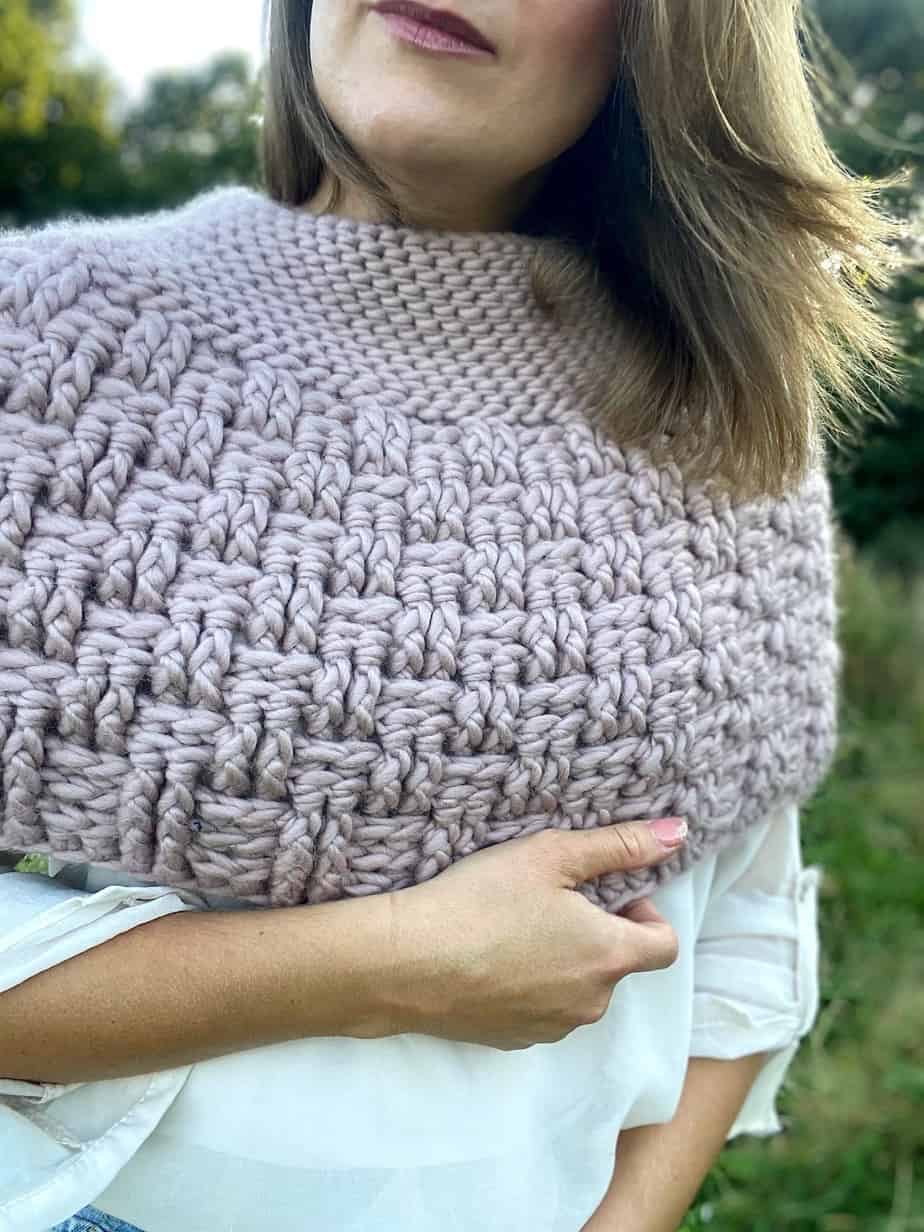 close up of pink basketweave stitch crochet cape in chunky yarn