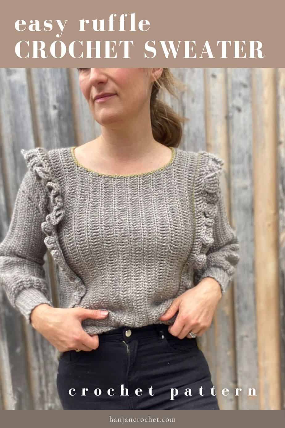 woman wearing grey ruffle stitch crochet sweater tucked into black jeans