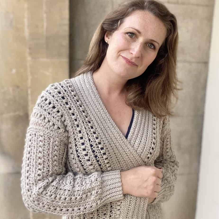 Woman pulling on cosy cardigan.