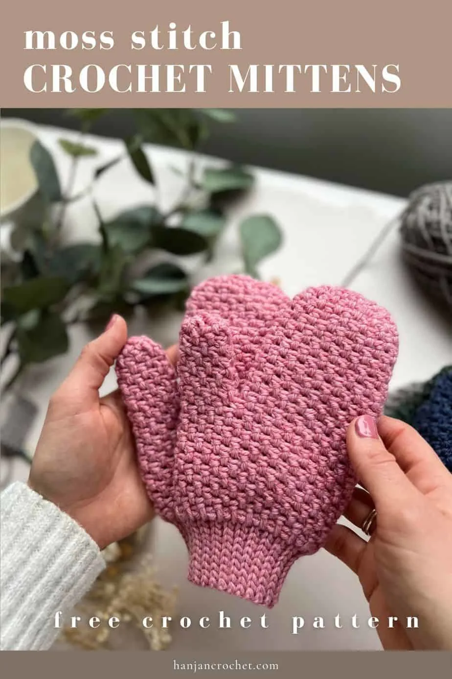 hands holding pink moss stitch crochet mittens with slip stitch rib