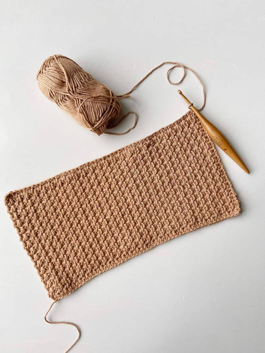 crochet swatch in brown cotton yarn showing the herringbone crochet moss stitch in flat rows