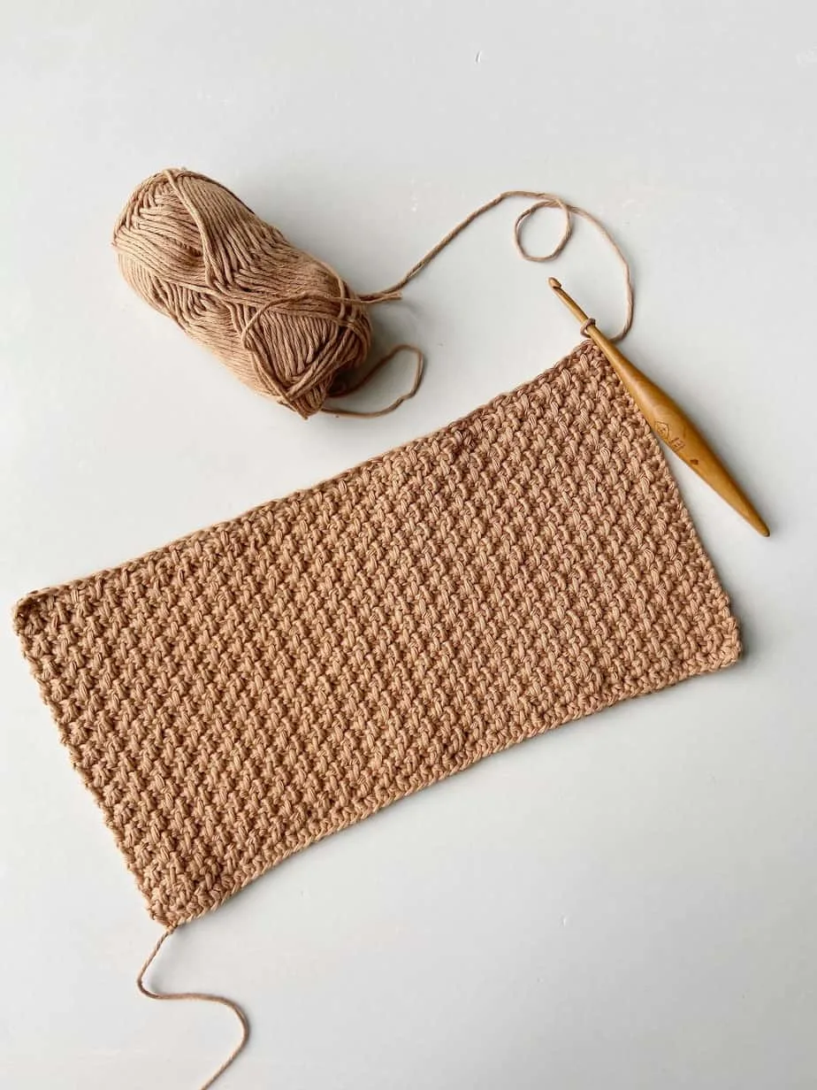 crochet swatch in brown cotton yarn showing the herringbone crochet moss stitch in flat rows