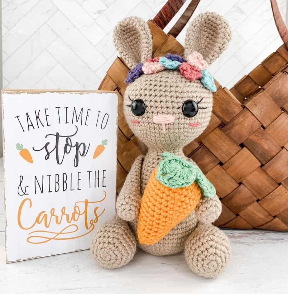 Crocheted bunny holding a carrot.