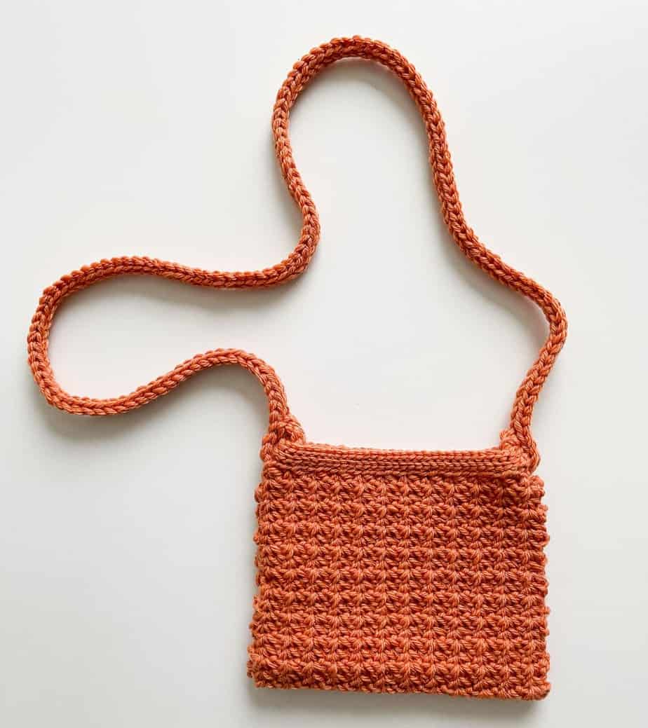 Orange crochet clutch bag.