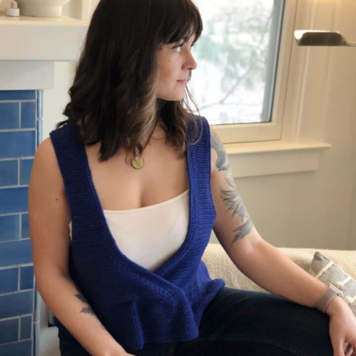 Woman wearing blue crochet vest.