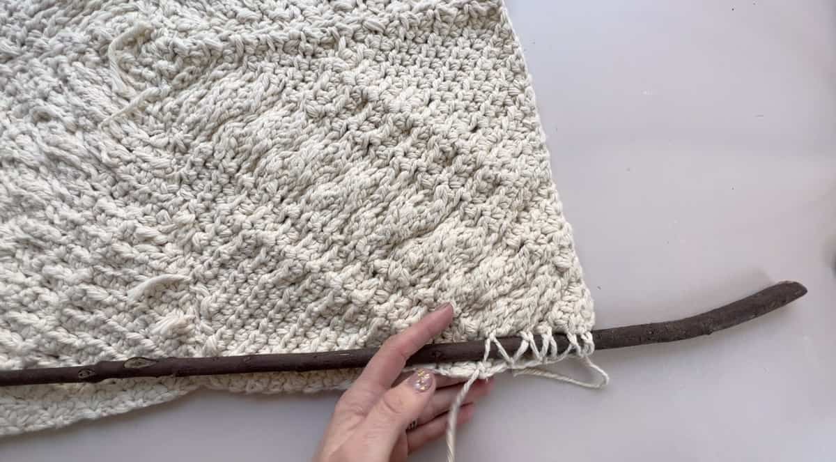 how to attach a wooden pole to a crochet wall hanging