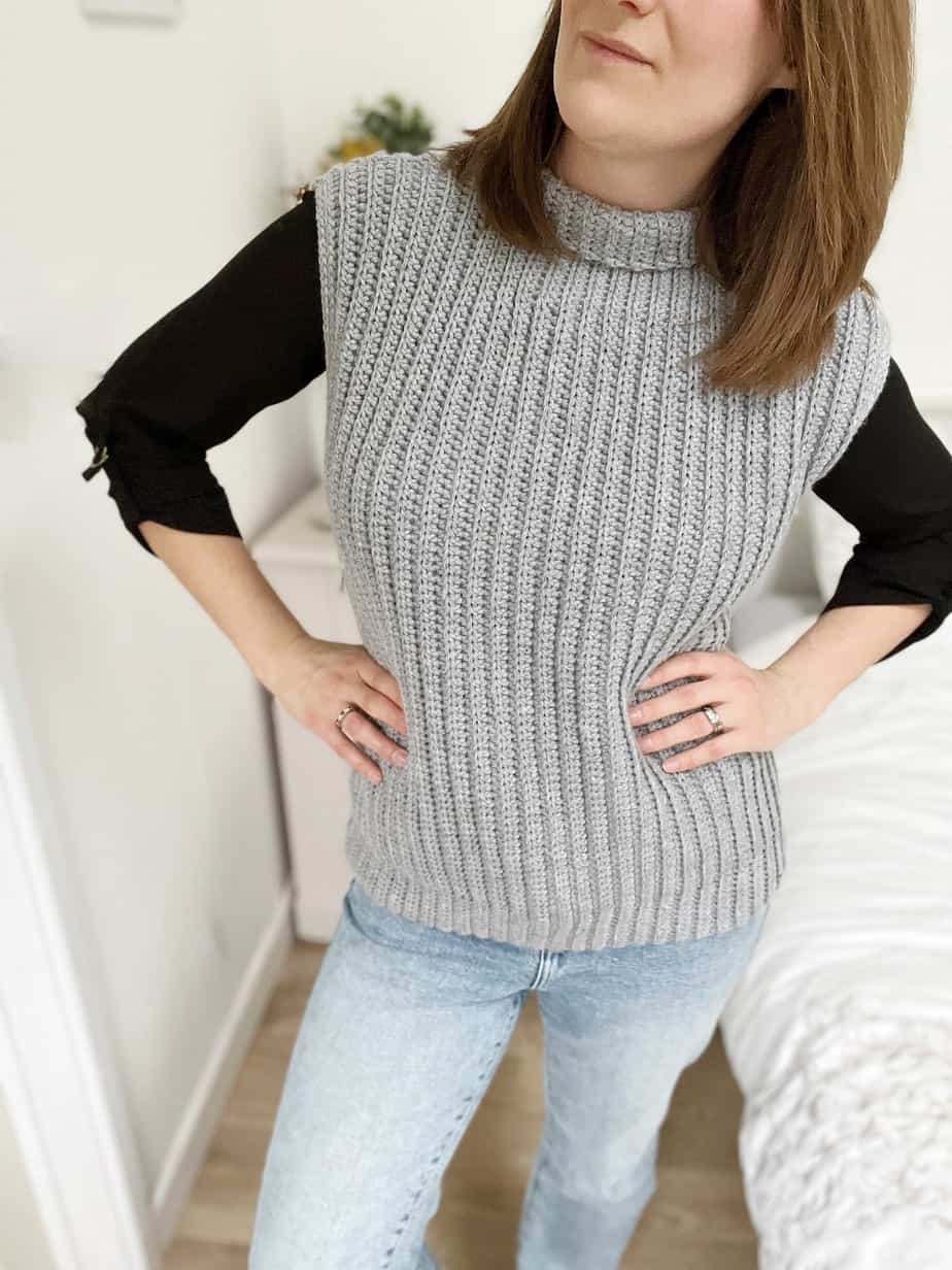 woman wearing sleeveless crochet pullover in grey