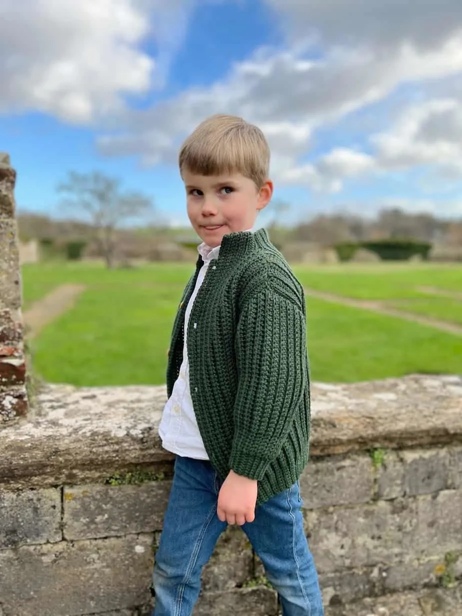 young boy wearing easy crochet cardigan in green