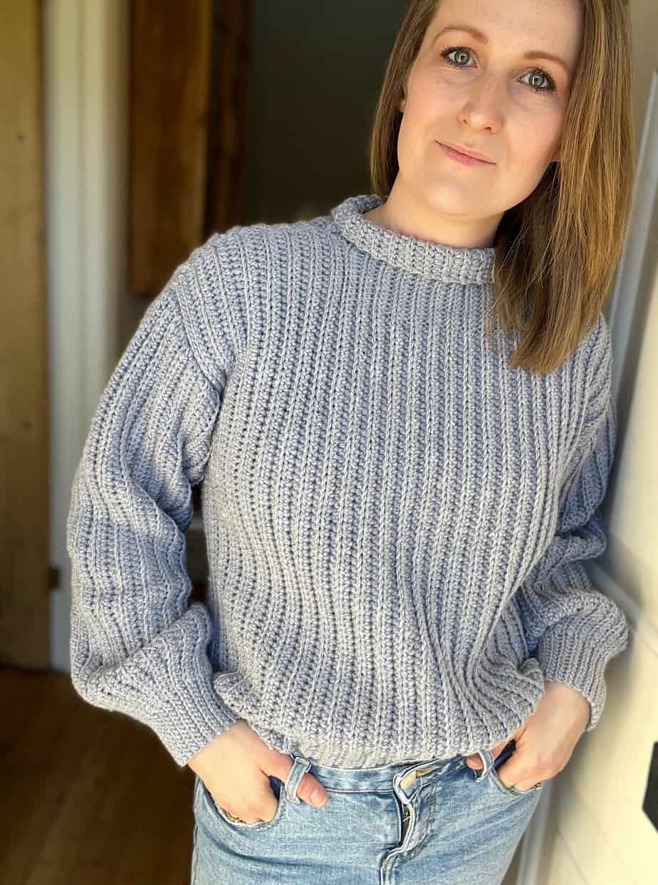 easy crochet sweater patterns for beginners shown on woman in grey