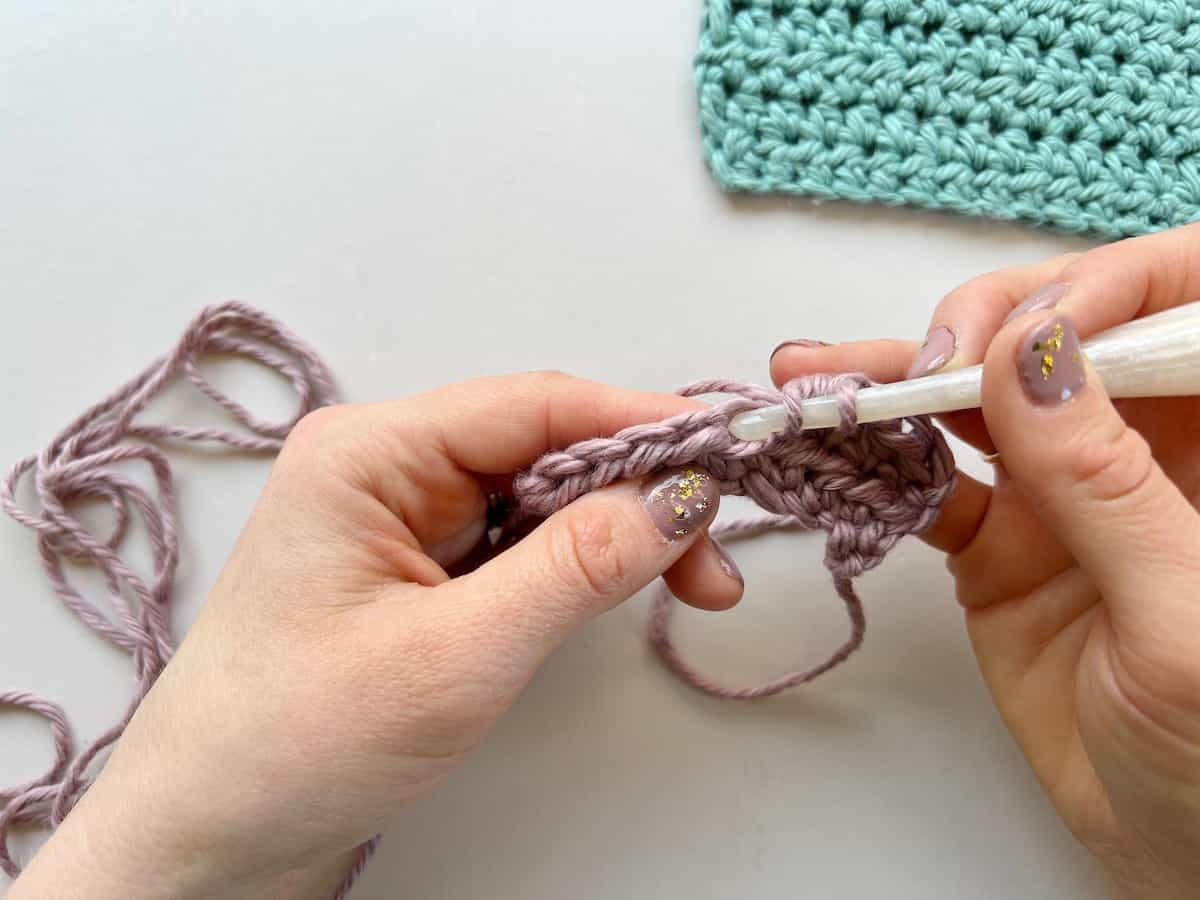 half double crochet stitch step 2 insert hook into stitch