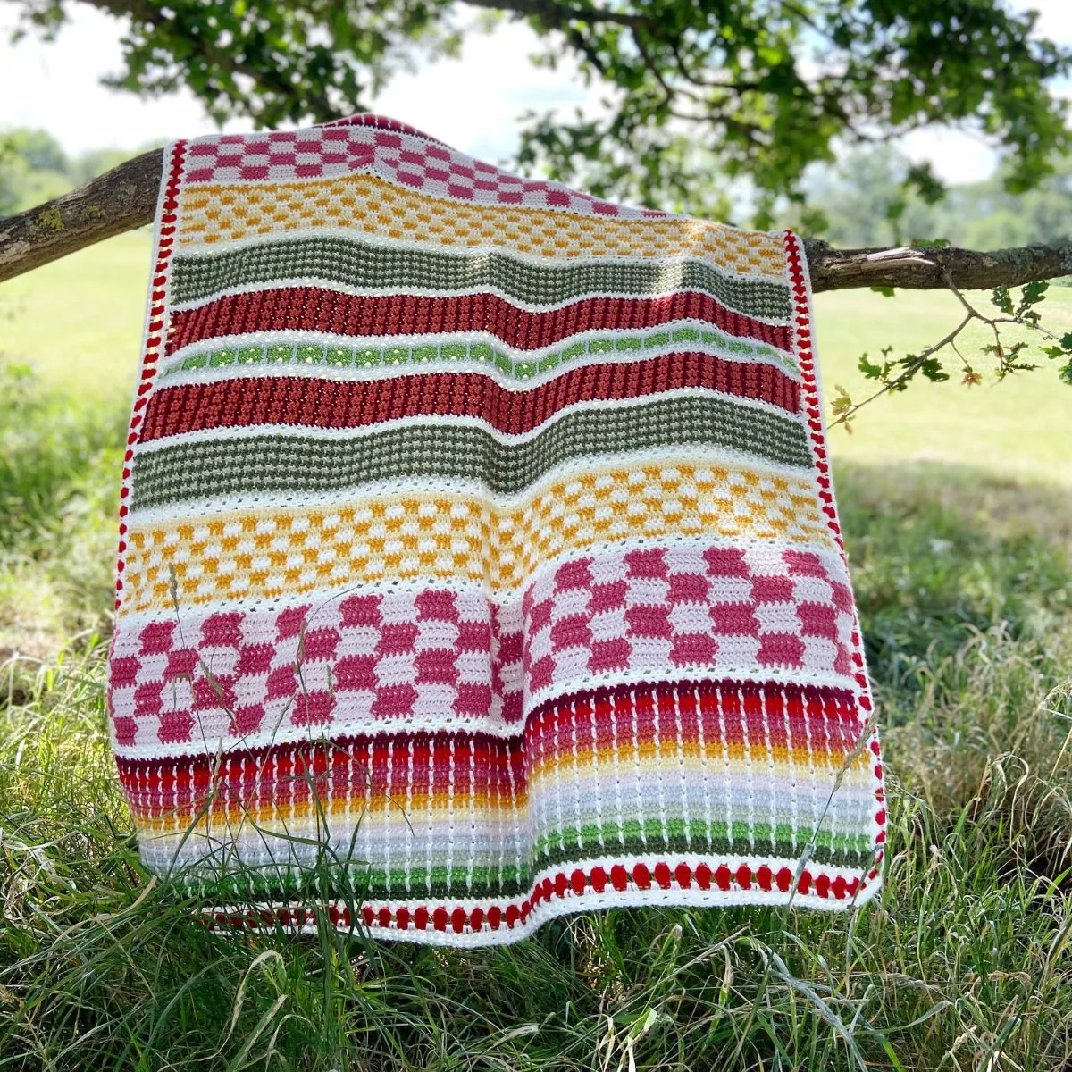 Colorful crochet sampler blanket blowing the breeze.