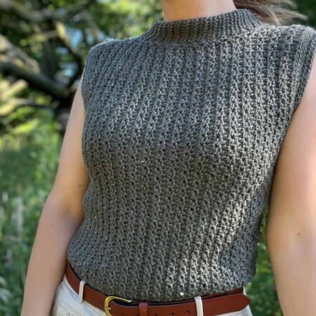 Woman wearing close fitting crochet sleeveless top pattern.