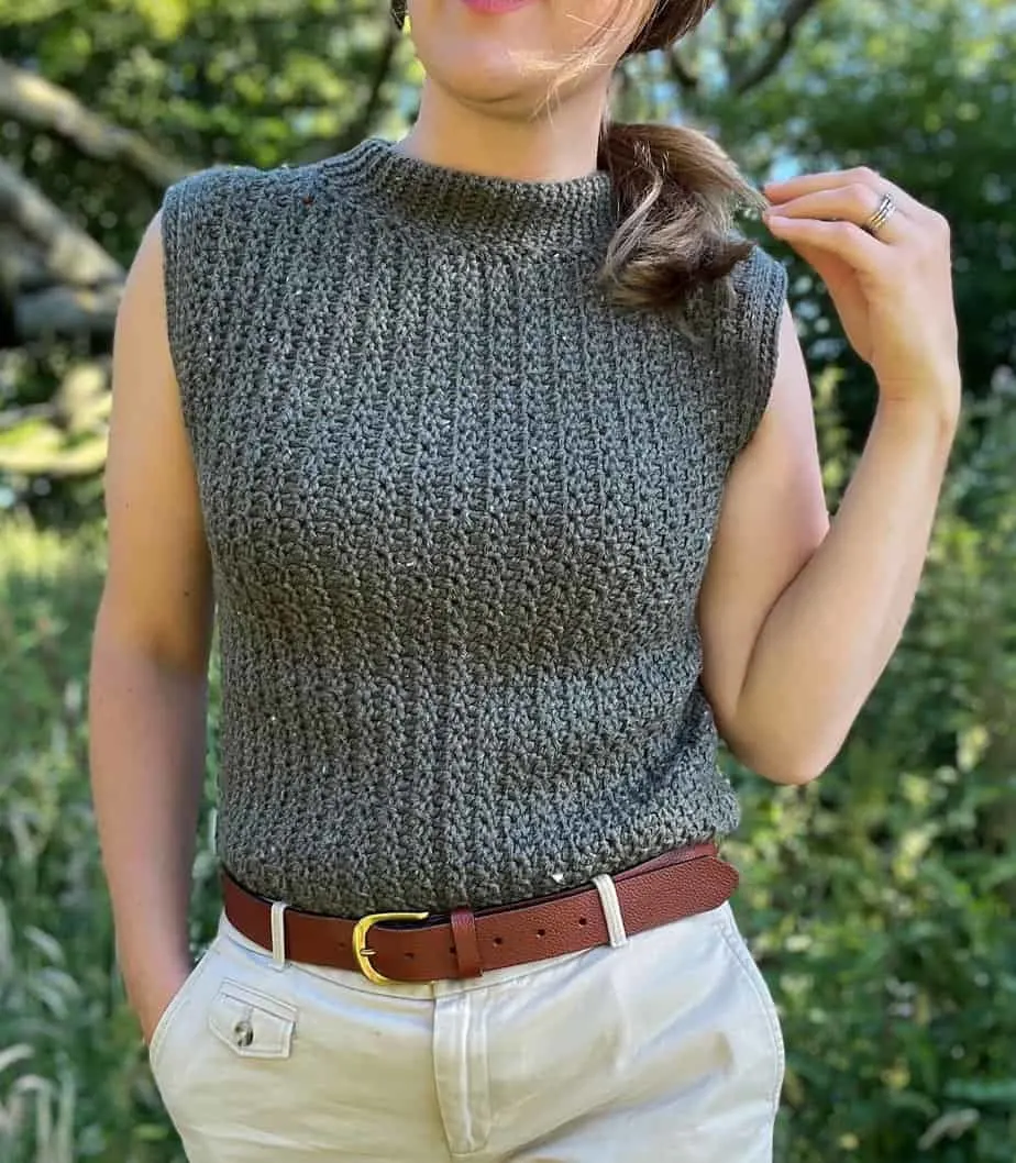 Woman in crochet sleeveless top pattern with crew neck collar.
