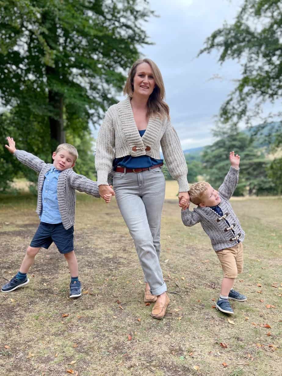 Woman and 2 boys wearing matching crochet cardigan patterns.