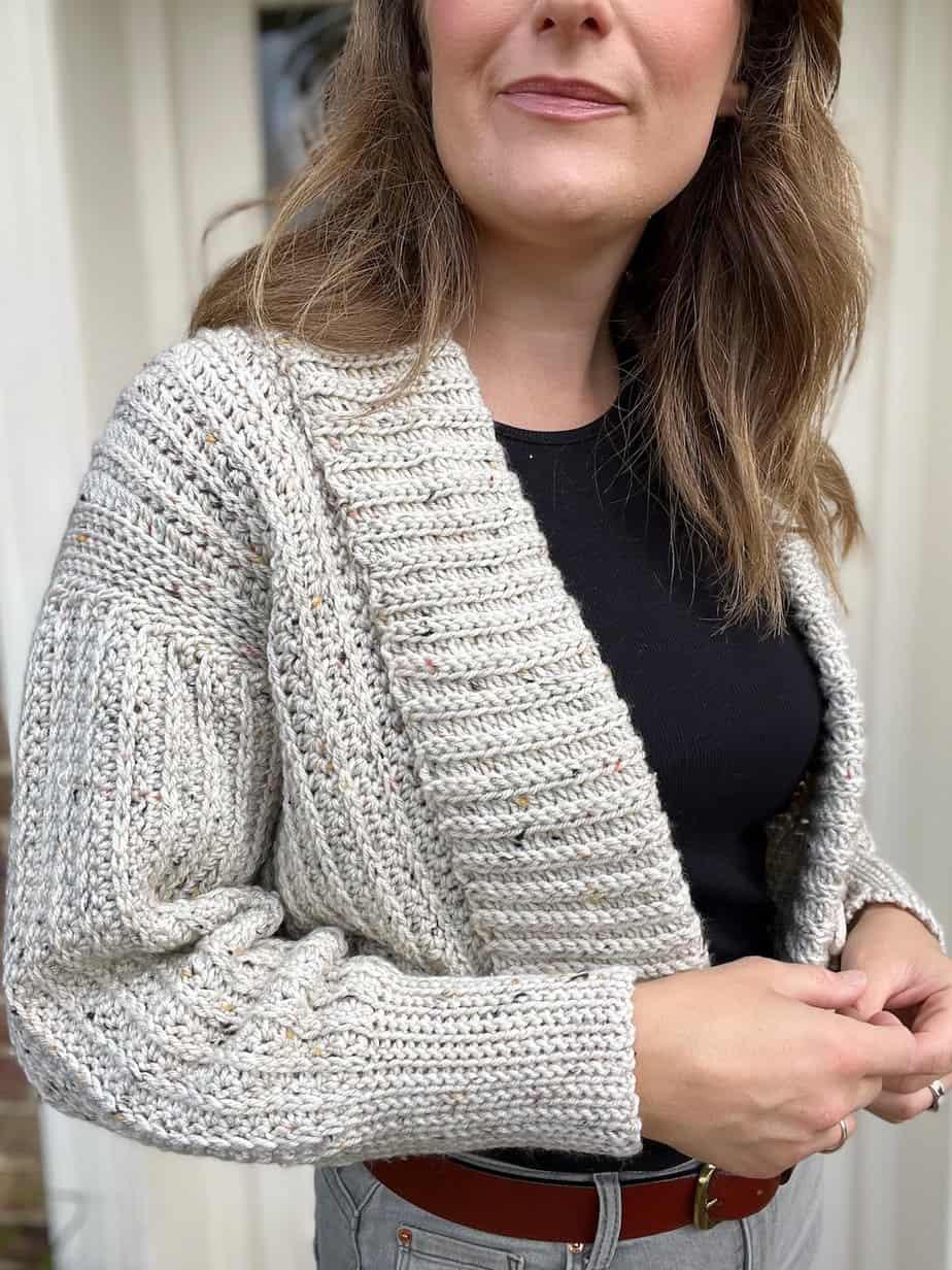 Close up of crochet bolero with rolled collar.