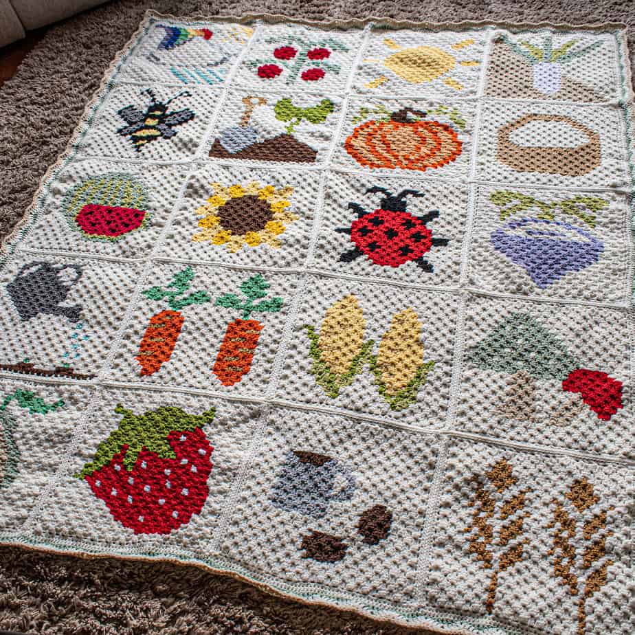 Crochet C2C afghan pattern laid out on floor with 20 different C2C square patterns.