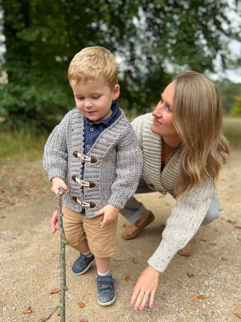 Mom and son wearing matching crochet cardigans.