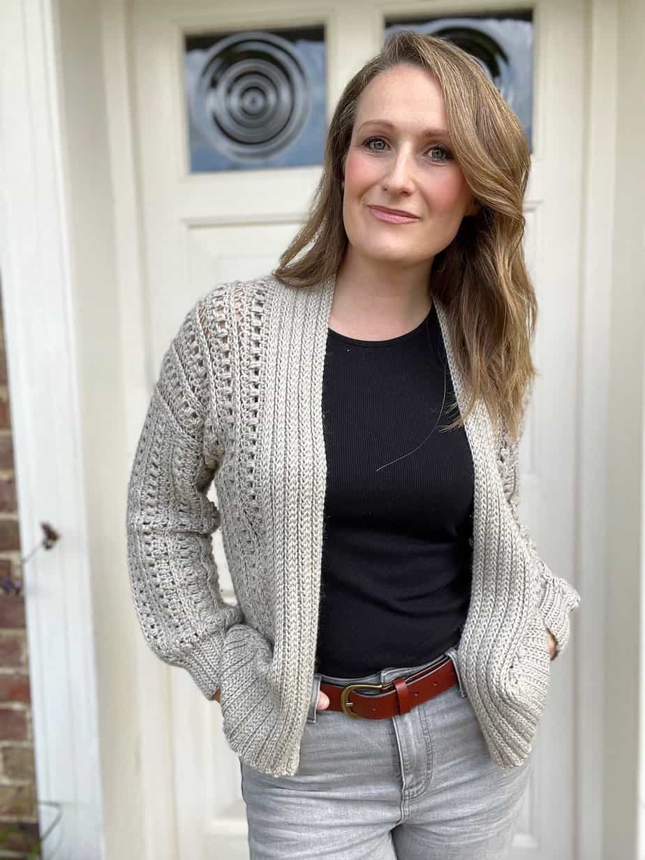 Woman wearing lightweight crochet cardigan pattern with puff stitches.