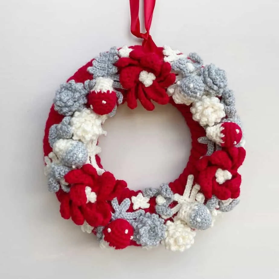 Red, white and grey crochet wreath with poinsettias.