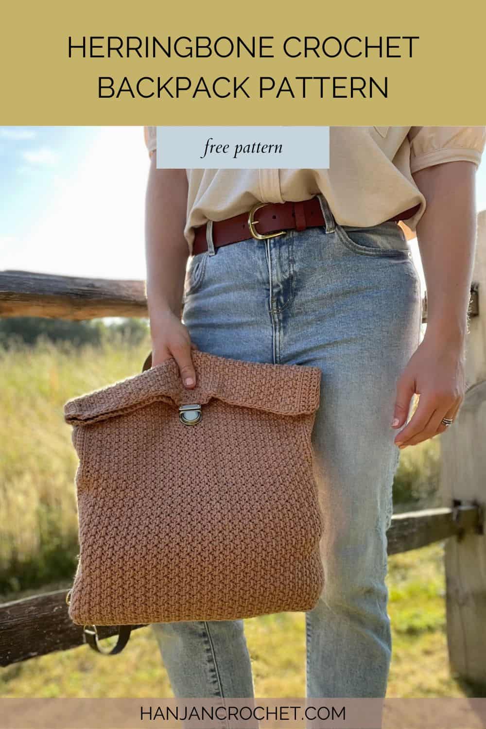 Person holding  a herringbone crochet rucksack. 