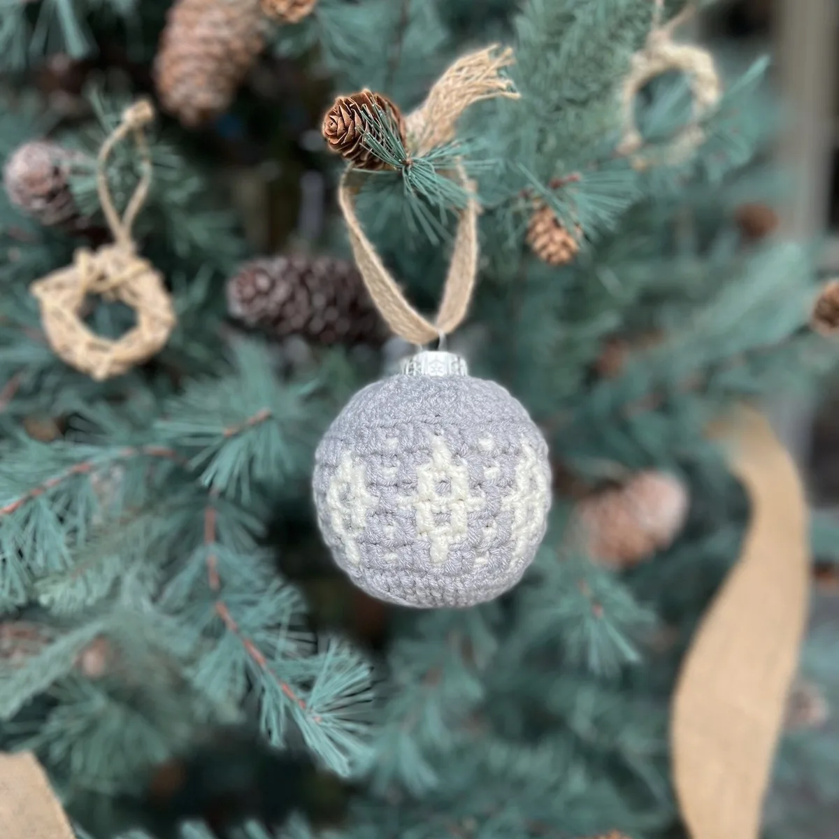 Starlight crochet bauble decoration in grey and white.