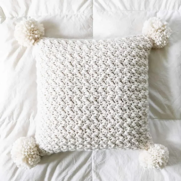 Chunky crochet pillow pattern in cream.