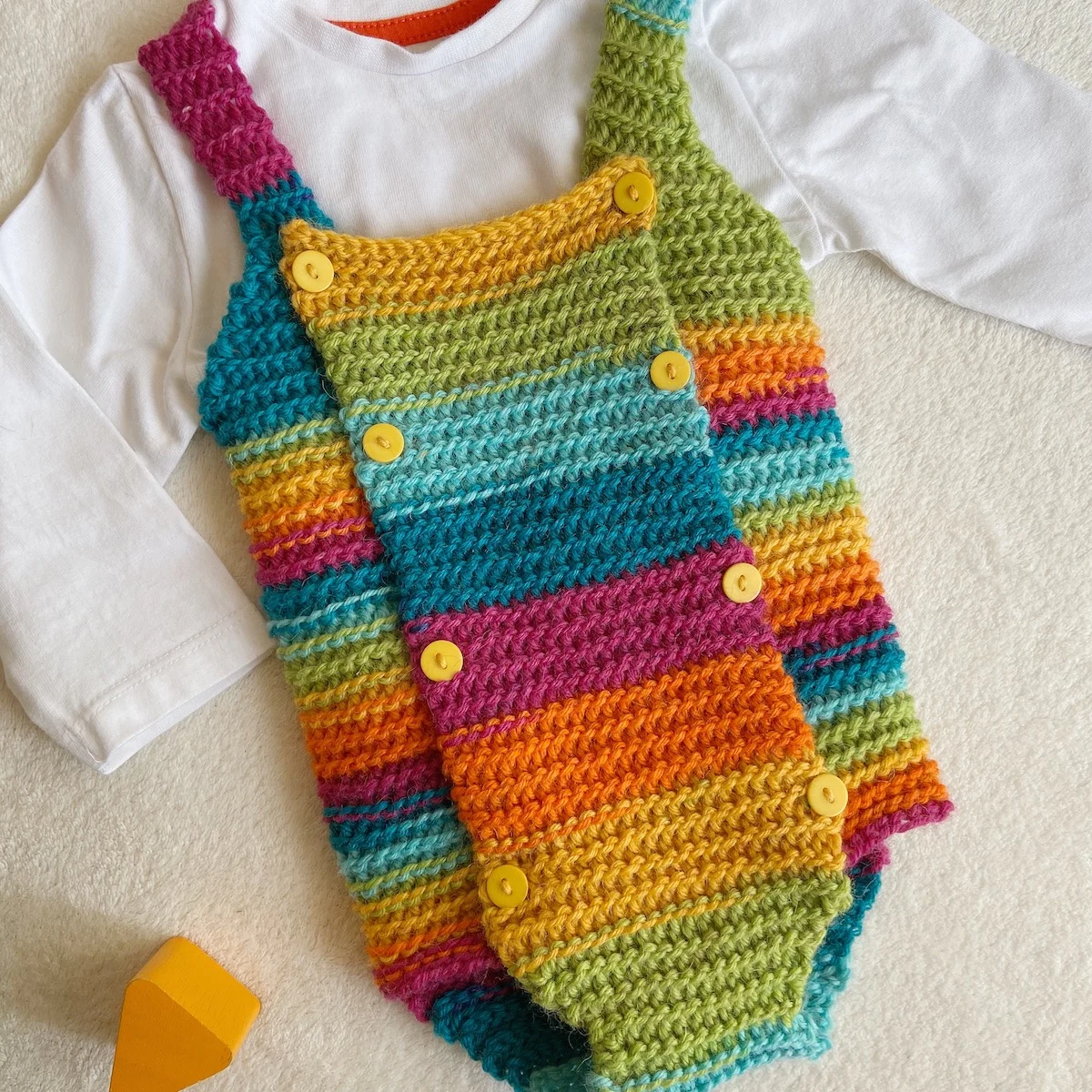 Close up of baby crochet babygrow pattern.