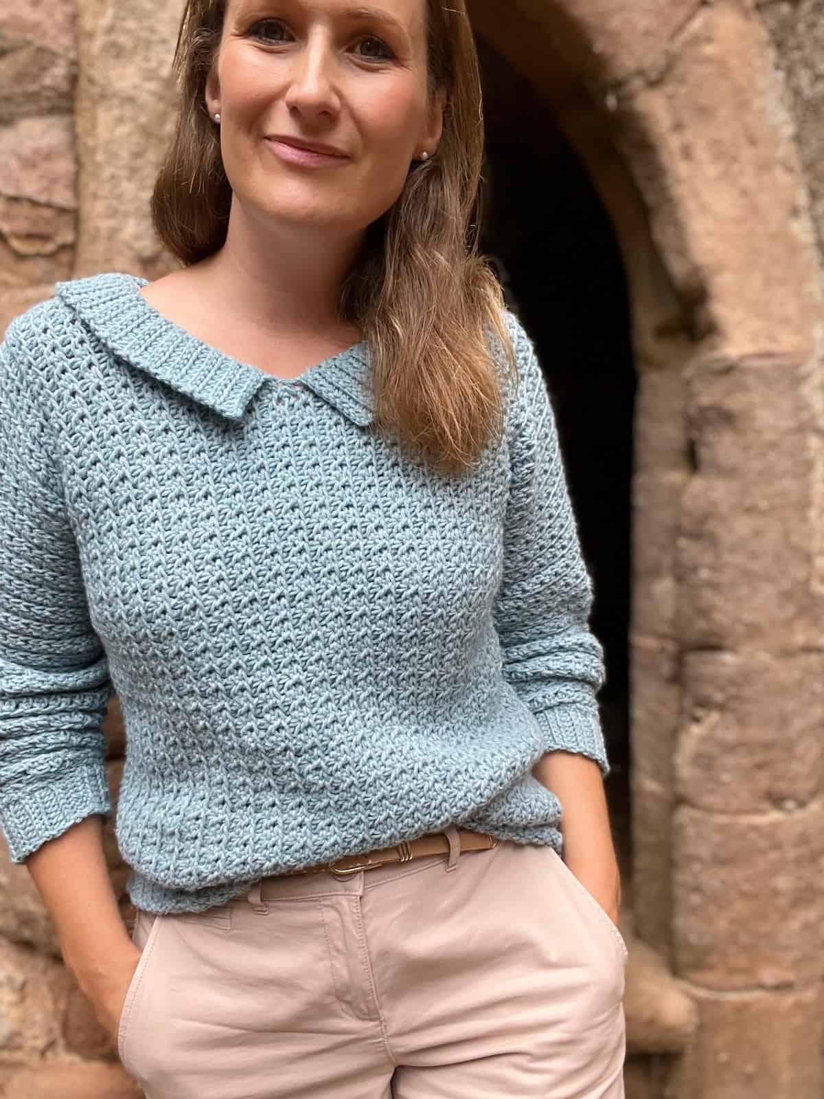 Woman wearing one piece crochet sweater pattern.