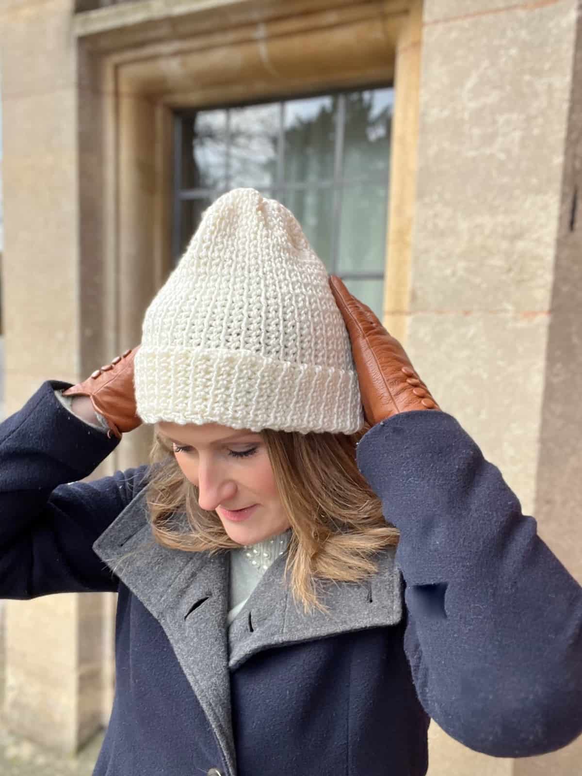 Woman wearing basic crochet beanie pattern in cream.