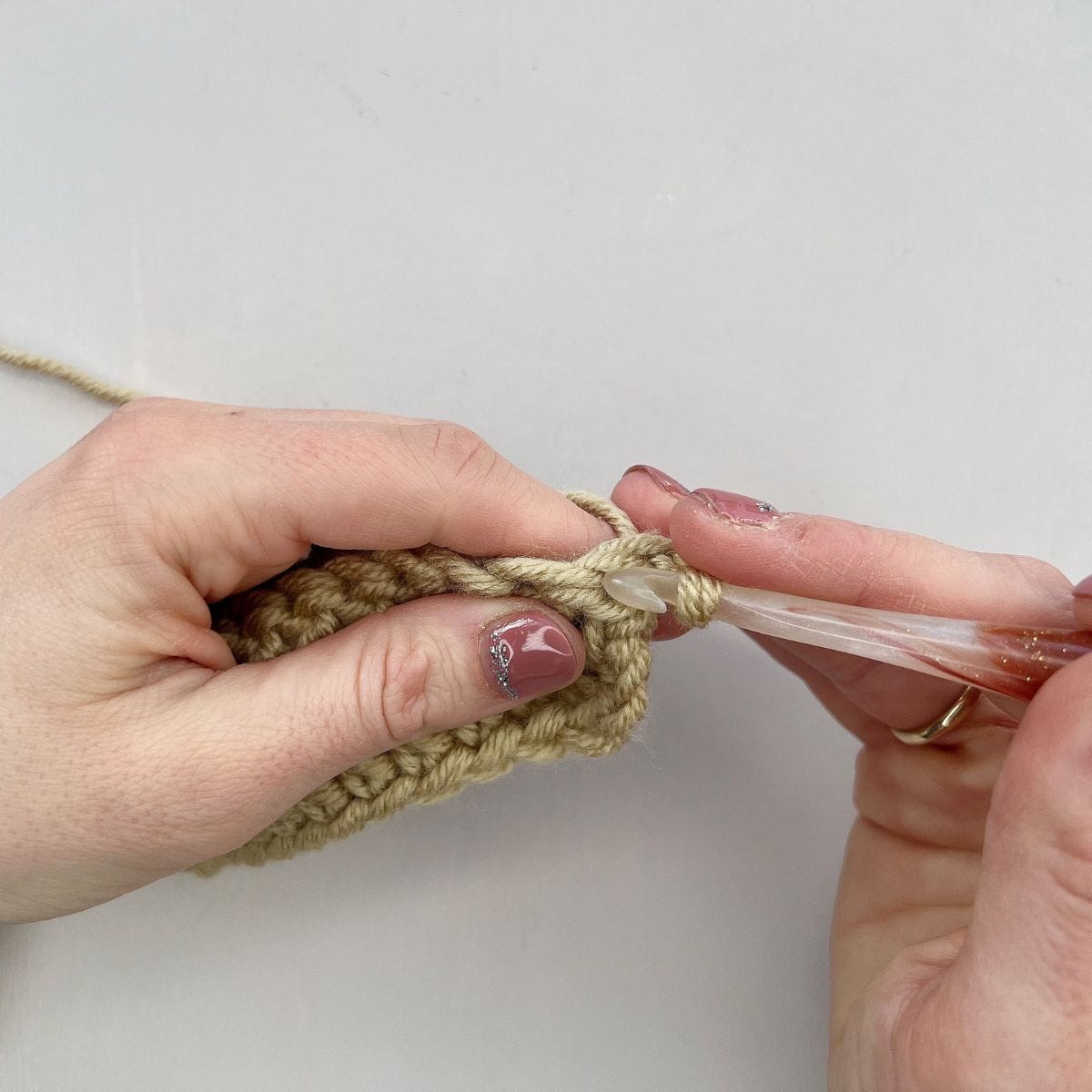 Inserting crochet hook into stitch.