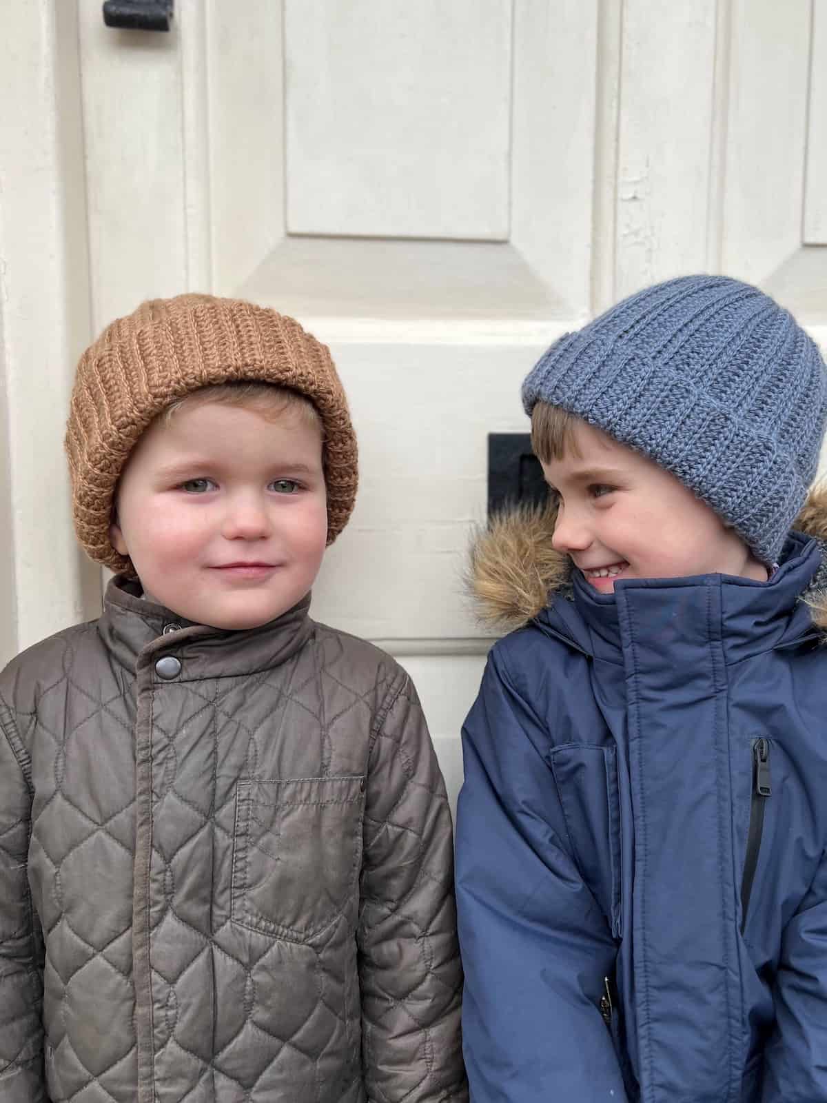 Two boys wearing simple ribbed crochet hats.