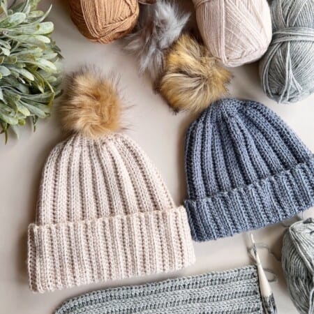 Collection of easy ribbed crochet hat patterns on table.