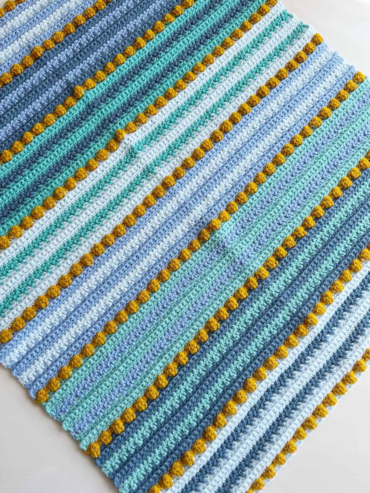 Bobble stitch crochet blanket in bright colours.