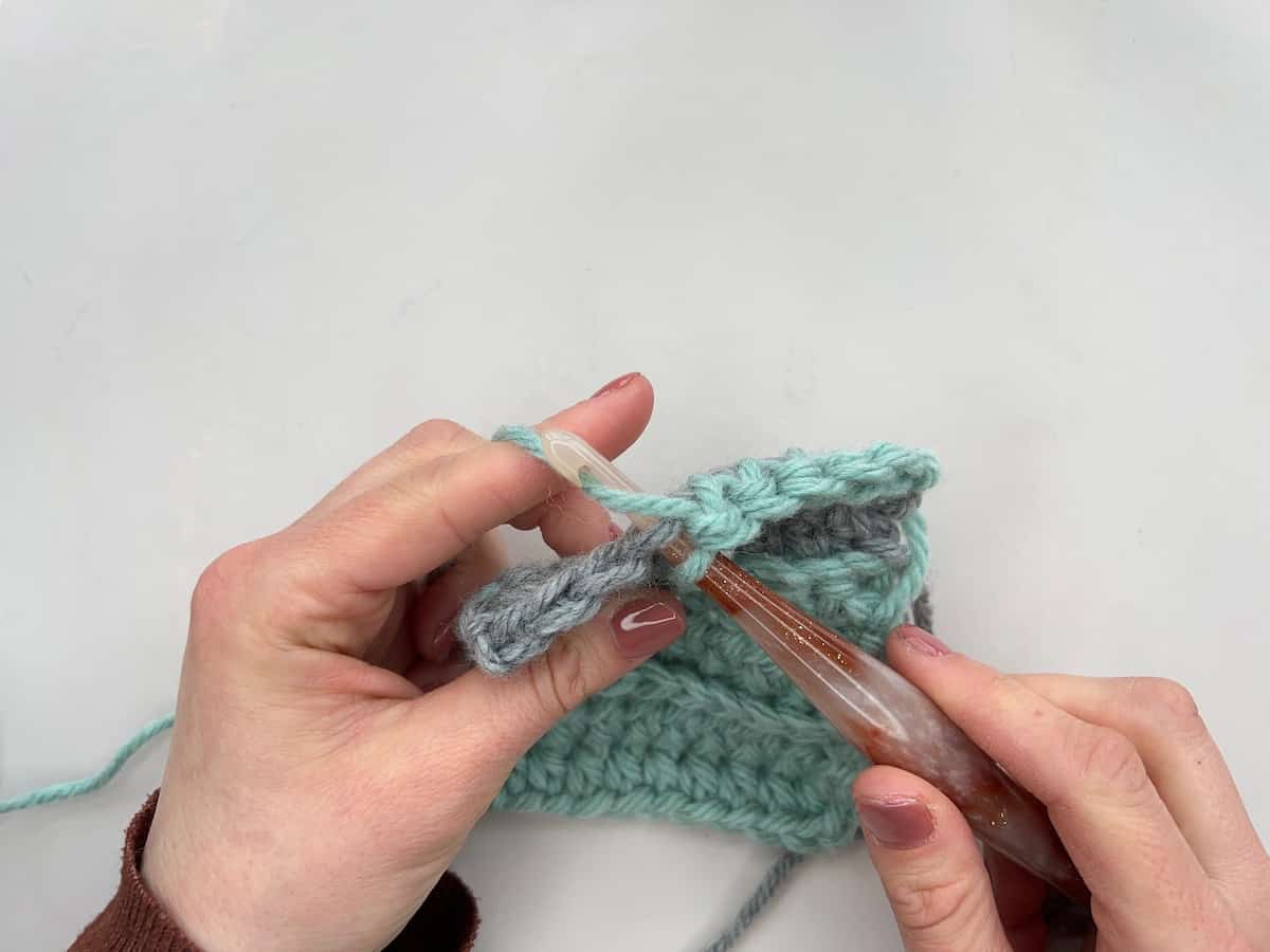 Crochet hook being inserted into the front loop only of a stitch.