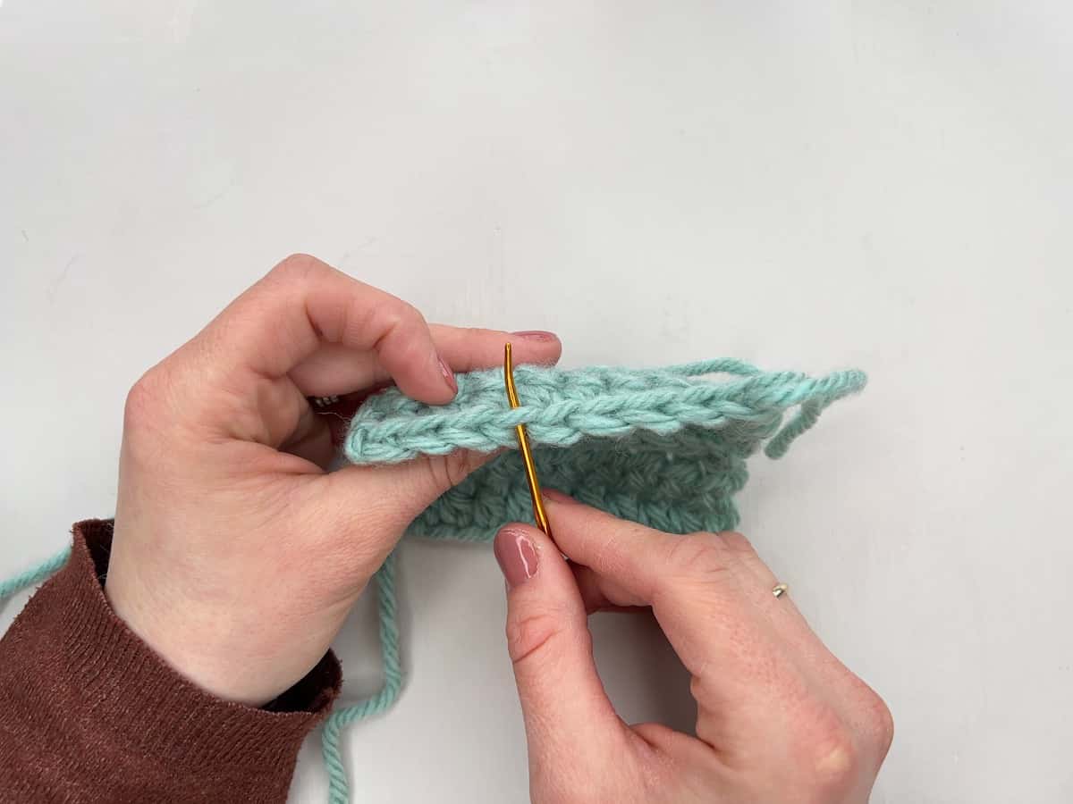 Back loop only crochet position of stitch being show with a needle.