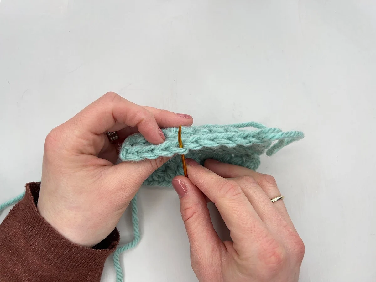 Front loops only crochet position show with a need on swatch.