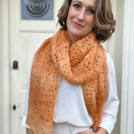 Elegant scarf crochet patten in orange mohair yarn.